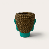 Vela escultórica THE IBIZA CANDLES Green Turquoise con forma de cabeza de Buda en color turquesa y detalles dorados.